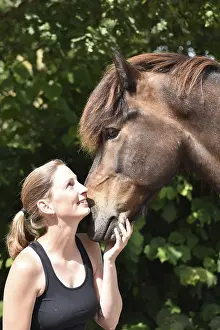 Young woman in close contact with her Icelandic horse