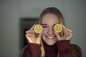 Young woman, cutting fruit, fooling around in the kitchen