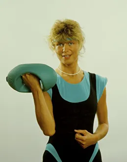 Young woman doing gymnastics with dumbbells