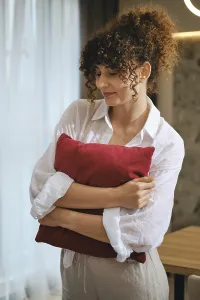 A young woman dressed in a white loose shirt
