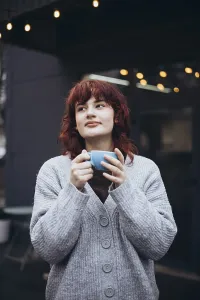 A young woman enjoys a coffee in a cafe terrace