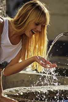 Young woman at the fountain