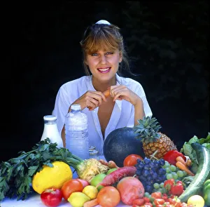 Young woman with fruit and milk
