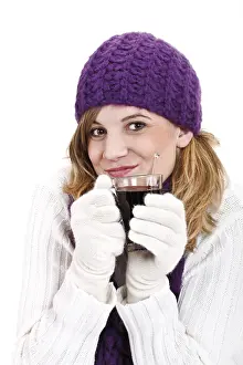 Young woman holding a glass of mulled wine