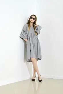 Young woman posing in a loose-fitting linen dress