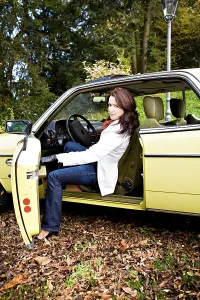 Young woman in a post-war classic car
