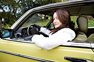 Young woman in a post-war classic car