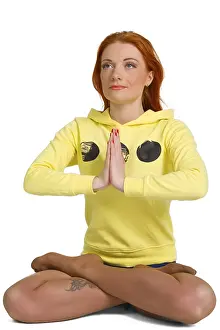 Young woman practicing yoga in the lotus position Isolated against white background