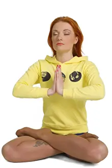 Young woman practicing yoga in the lotus position Isolated against white background