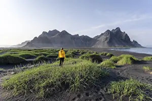 Young woman with rain jacket hiking