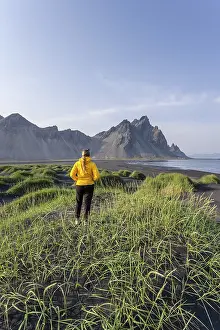 Young woman with rain jacket hiking