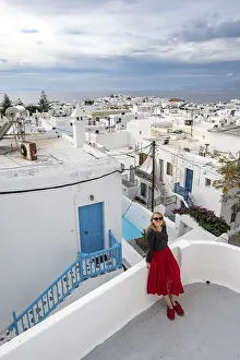 Young woman with red skirt on a terrace