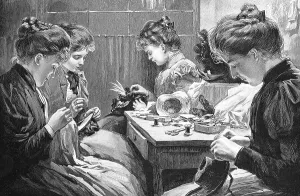 Four young woman sewing at a table