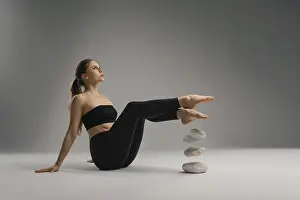 A young woman sits on a smooth surface