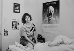 Young woman, student, with poster of Helnwein