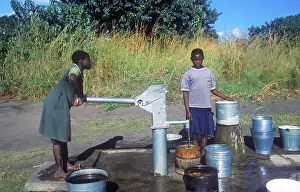 Two young woman at a well in a village near Kande on Lake Malawi