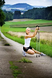 Young woman warming up for Nordic Walking