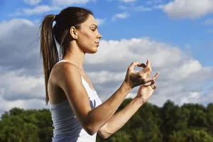 Young woman during yoga meditation in the park