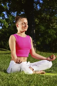 Young woman during yoga meditation in the park