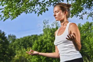 Young woman during yoga meditation in the park