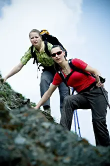 Two young women hiking on steep terrain