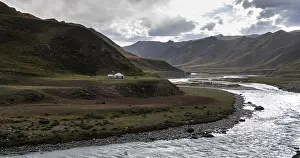 Yurt by a river, Desolate mountain landscape